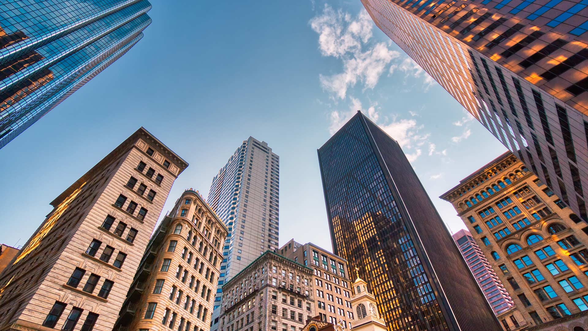 Boston downtown financial district and city skyline with blue skies.